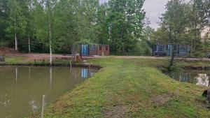 a view of a camping site with a lake at Dīķu oāze in Atspuki