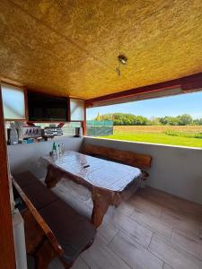a dining room with a table and a large window at Apartman Abramović in Topusko