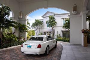 a white car parked in front of a house at Sandals Royal Bahamian All Inclusive Adults Only in Nassau
