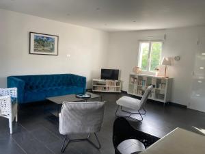 a living room with a blue couch and chairs at Les Hauts de Bassens in Bassens