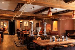 a restaurant with tables and chairs in a room at Plough Inn in Lupton