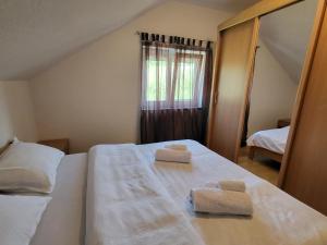 a bedroom with two towels on top of a bed at Duvnjak Rooms & House in Livno