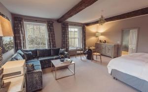 a living room with a bed and a couch at Plough Inn in Lupton