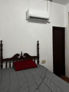 a bedroom with a bed with a television on the wall at Casa-Museo centro de Caguas in Caguas +23 photos