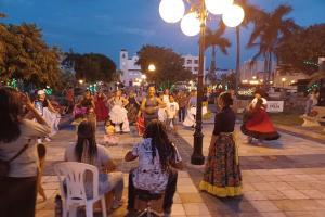 a group of people dancing on a street at night at Casa-Museo centro de Caguas in Caguas