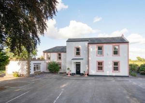 an image of a house with a parking lot at Big Pink House in Mealsgate