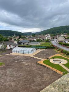 an empty parking lot with a greenhouse in a town at Le clos du Breuchin in Breuchotte