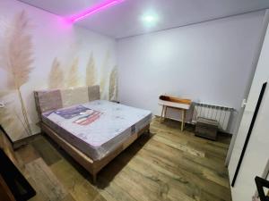 a bedroom with a bed in the corner of a room at s2 fontaine in Nabeul