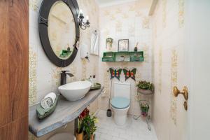 a bathroom with a sink and a toilet and a mirror at Don Sidónio Alojamentos in Portimão +36 photos
