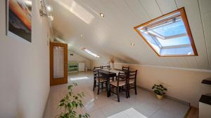 a dining room with a table and a skylight at Apartman Mario with pool by Villas Guide in Blato
