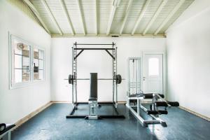 a gym with two tread machines and a mirror at Xenios Port Marina Hotel in Pefkochori