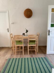 a dining room with a table and chairs with acomputer at Tornácos Vendégház in Szécsény