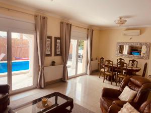 a living room with a couch and a table at Villa CARMENÇÓ in Empuriabrava