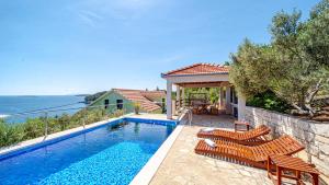 a villa with a swimming pool and a house at Apartman Mario with pool by Villas Guide in Blato