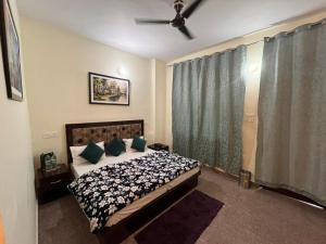 a bedroom with a bed and a ceiling fan at Hotel AAA And Restaurant in Gupta Kāshi