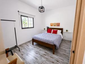 a bedroom with a bed with red pillows at Quinta da Ponte das Hortas 3 in Elvas +38 photos