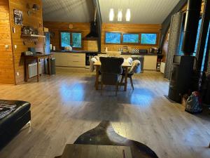a living room with a table and a kitchen at Chalet Isard in Gère-Belesten