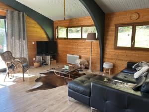 a living room with a couch and a table at Chalet Isard in Gère-Belesten