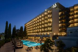 a hotel with a swimming pool at night at Barceló Roma in Rome