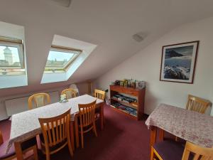 a dining room with a table and chairs at Penzión Borievka in Poprad