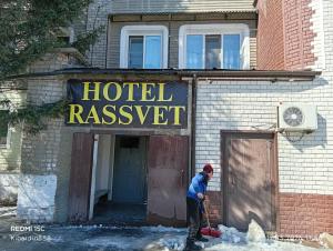 a man is shoveling snow out of a hotel restaurant at Rassvet in Lenīnogorsk
