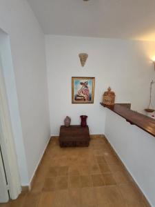 a hallway with white walls and a painting on the wall at lagoon apartment 2 in Moulay Bousselham