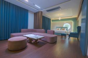 a living room with a couch and a bed at Hotel Nova Platinum Ujjain in Makoria Ām