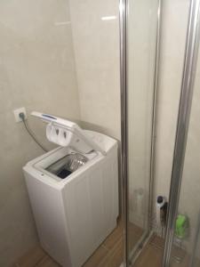 a washing machine in a bathroom with a shower at Nice apartment with amazing views in Kriopigi +31 photos