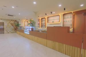 a restaurant with a counter in a room at Hotel Nova Platinum Ujjain in Makoria Ām