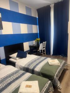 a hotel room with two beds and a table at Firenze inn 21 Florence in Florence