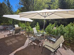 a table and chairs with a white umbrella at Pension Janský Potok I. in Janske Lazne