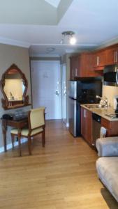 a kitchen with a table and a sink and a kitchen with a tablektop at Condo St Sauveur in Piedmont