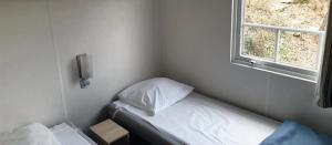 a small room with a bed and a window at Camping 2 étoiles - Piscine - ccbfida in Vernet-les-Bains