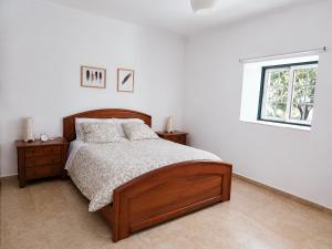 a bedroom with a wooden bed and a window at Quinta da Ponte das Hortas 2 in Elvas +29 photos
