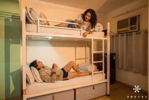 two women sitting on top of bunk beds at Zostel Delhi in New Delhi