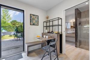 a home office with a desk and a sliding glass door at Chambre - Le Nid in Saint-Prouant