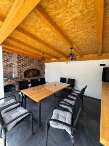 a dining room with a wooden table and chairs at Pool House in Toplica