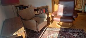 a living room with two chairs and a table at Gemütliches Doppelzimmer mit Balkon in Furth im Wald