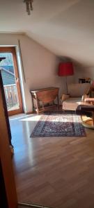 a living room with a couch and a table at Gemütliches Doppelzimmer mit Balkon in Furth im Wald