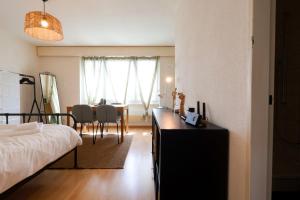 a bedroom with a bed and a dining room table at Cozy Apartment with Easy Access to Bern in Bern