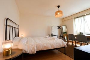 a bedroom with a bed and a table and chairs at Cozy Apartment with Easy Access to Bern in Bern