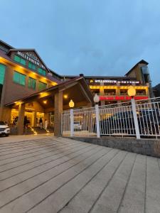 a building with a white fence in front of it at Millennium Inn Hotel Naran in Naran