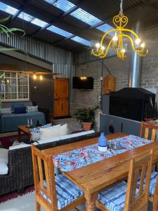 a living room with a table and a couch at God's Gift Cottages in Clarens
