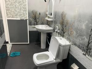 a bathroom with a toilet and a sink at Sea View Resort in Kallady +107 photos