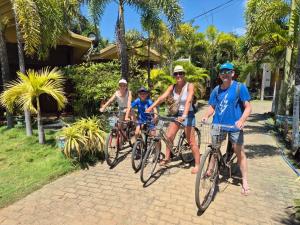 a group of people riding bikes down a sidewalk at Sea View Resort in Kallady