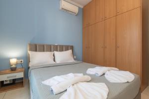 a bedroom with a bed with towels on it at The old inn in Laganas