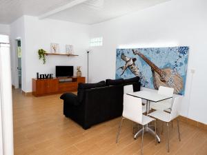 a living room with a black couch and a table at Quinta da Ponte das Hortas 1 in Elvas