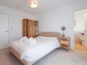 a bedroom with a bed with white sheets and a nightstand at Eden's Bloomdale in St Austell