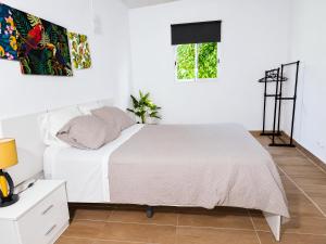 a white bedroom with a bed and a window at Quinta da Ponte das Hortas 1 in Elvas +30 photos