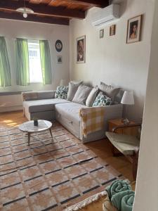 a living room with a couch and a table at Sárga-part Vendégház in Cserépváralja